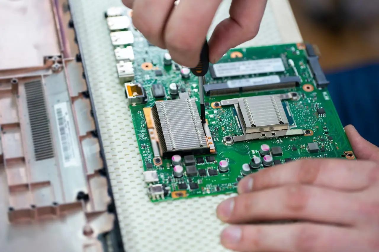 service center for laptop repair macro of a screwdriver holding a screw